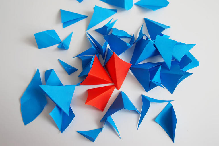 A majority of blue paper triangles, a minority of red paper triangles