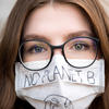 A girl wearing a protective mask with a "no planet B" slogan on it A girl wearing a protective mask with a "no planet B" slogan on it